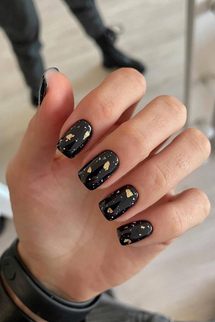 Short black nails with gold flakes