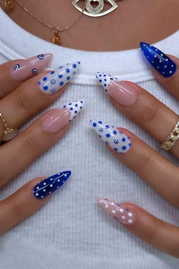 Blue and white nails with polka dots and evil eye design