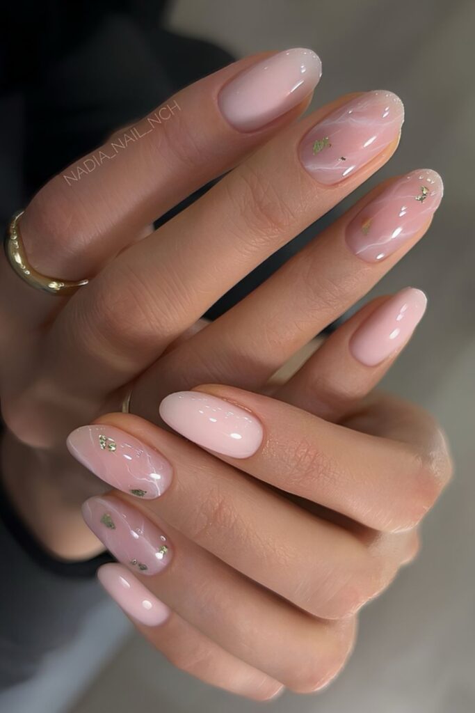 Milky pink marble nails with gold foil accents