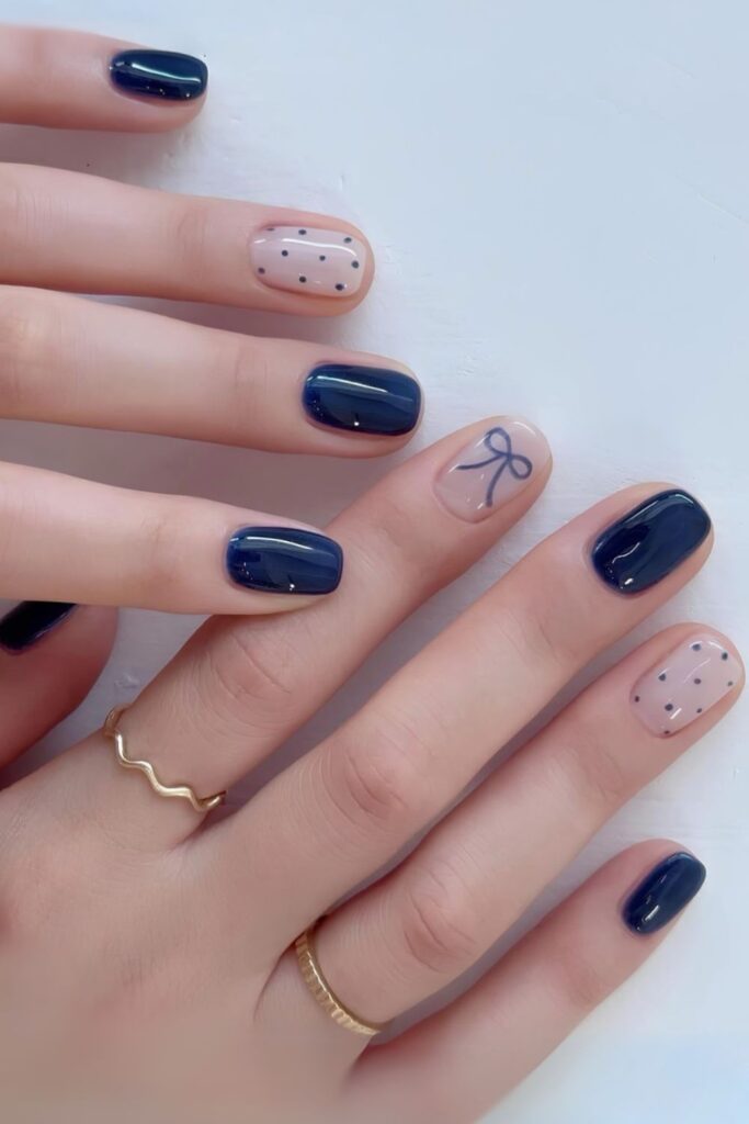 Navy blue jelly nails with dots and bow