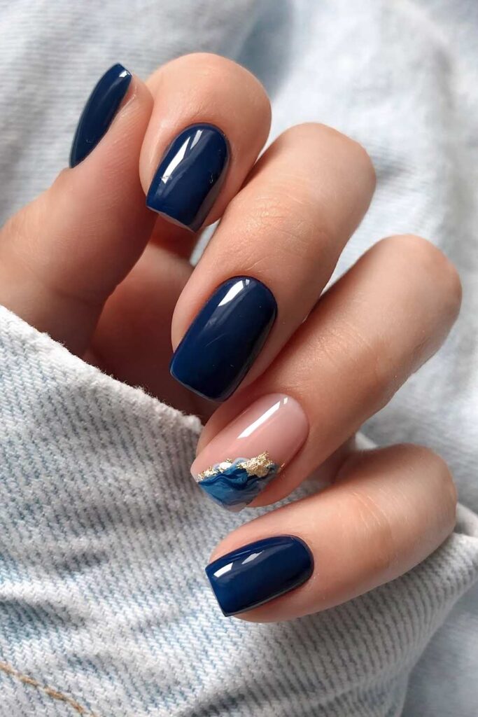 Navy blue manicure with marble effect and gold foil details