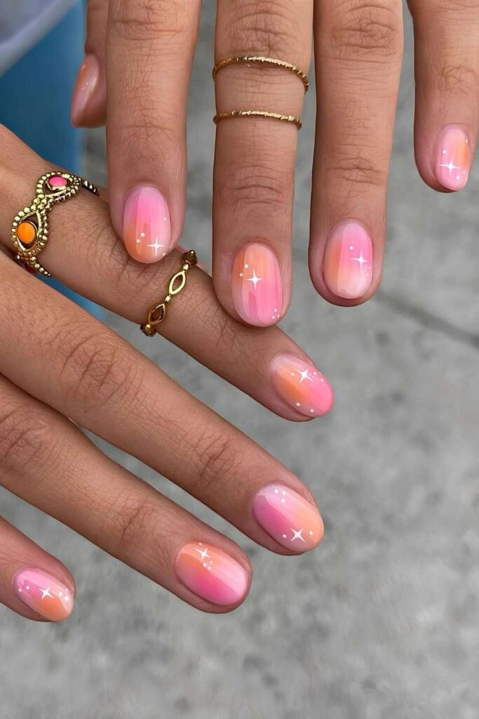 Pink and orange aura nails with tiny stars