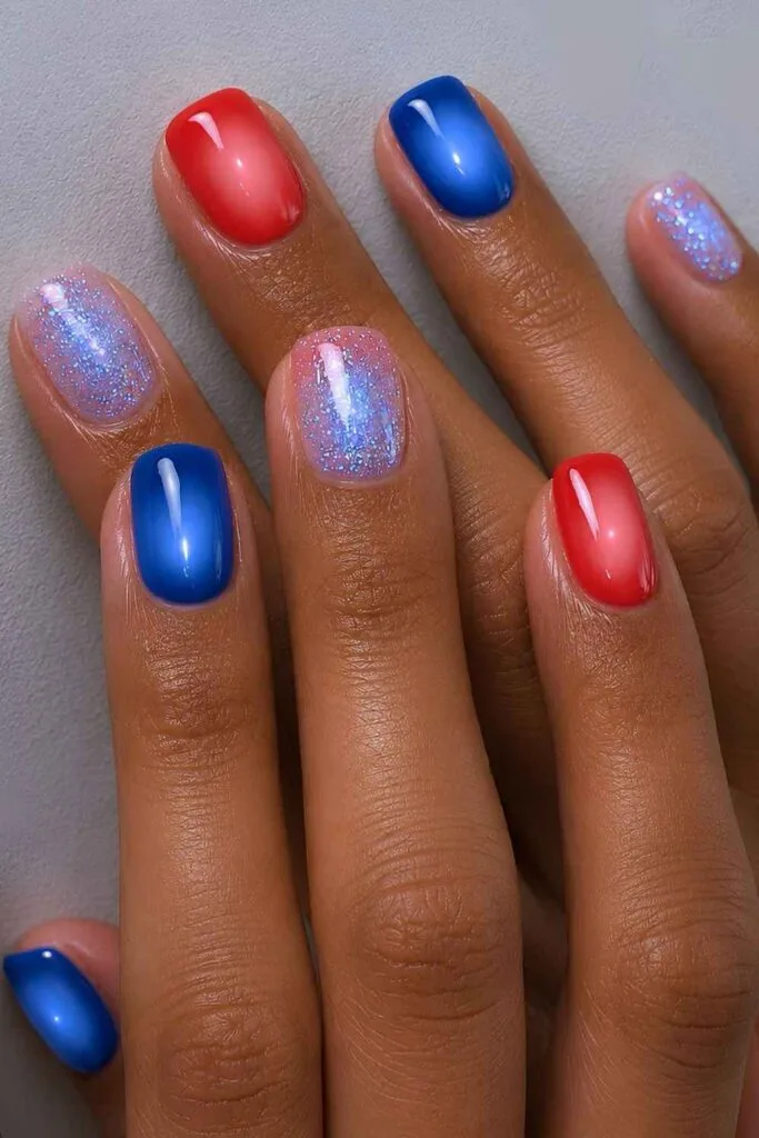Blue and red nails with aura and glittery effect