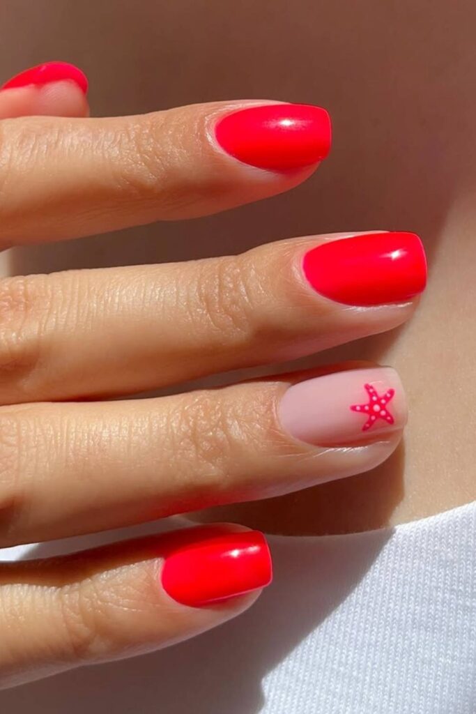 Bright red nails with starfish accent