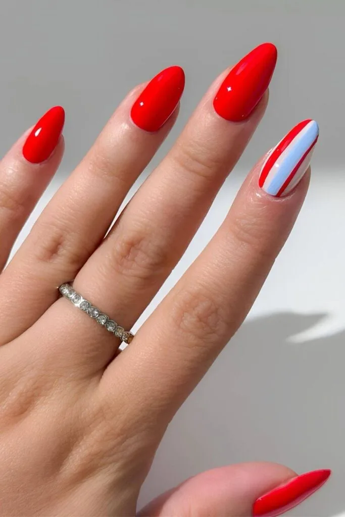 Bright red nails with stripesd accent nail