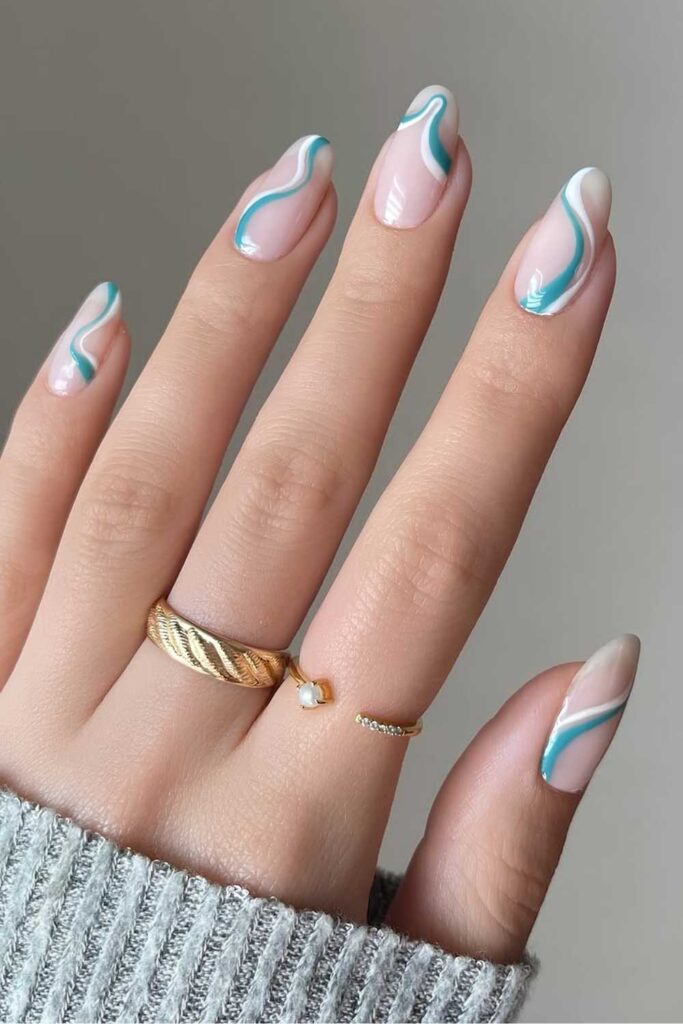 Milky white nails with blue and white swirls