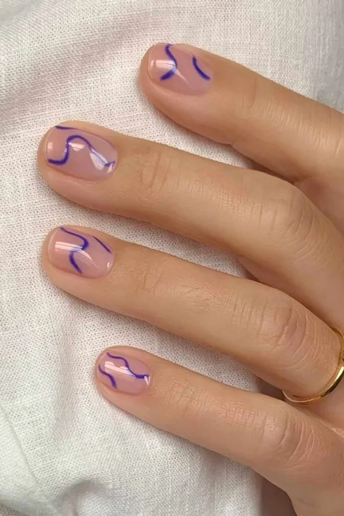 Natural nails with blue squiggles
