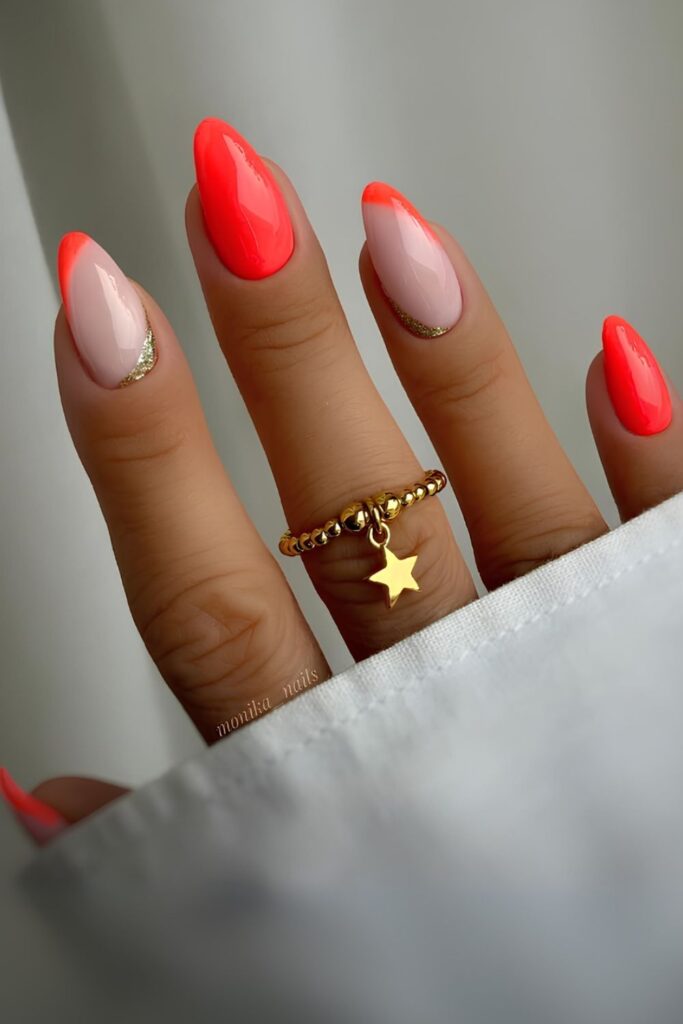 Neon orange nails with reversed French tip and gold detail