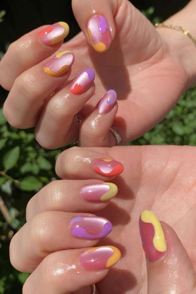 Pink cat-eye nails with colorful swirls
