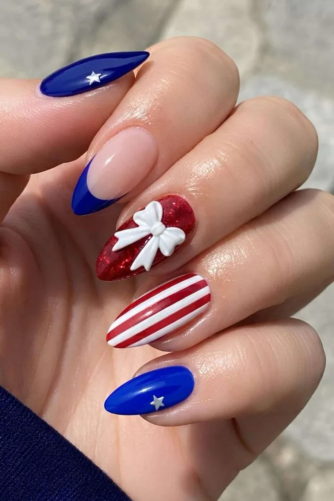 Red and blue nails with stripes, stars and 3d bow