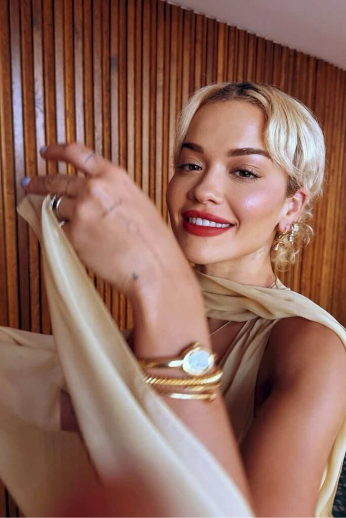 Rita Ora wearing a beige dress