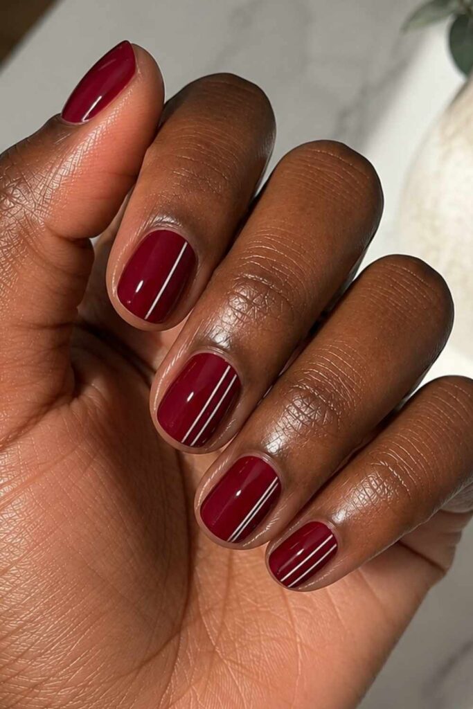 Ruby red nails with white stripe art