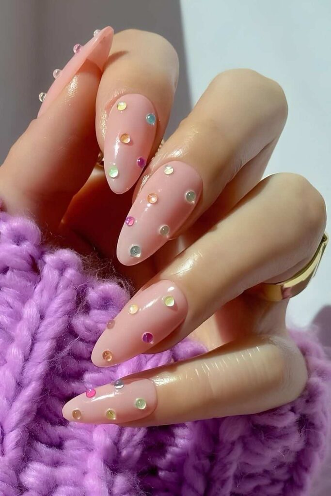 Soft pink nails with colorful gems