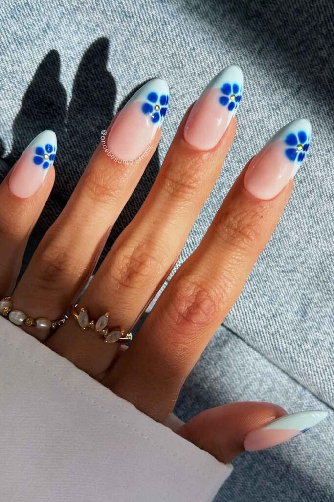Light blue French nails with blooming florals