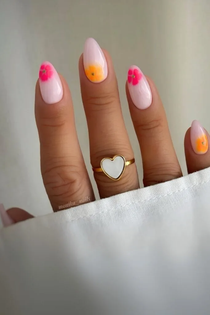 Milky pink nails with neon blooming flowers