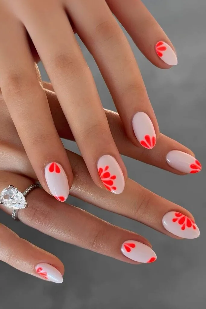 Milky white nails with neon coral petals