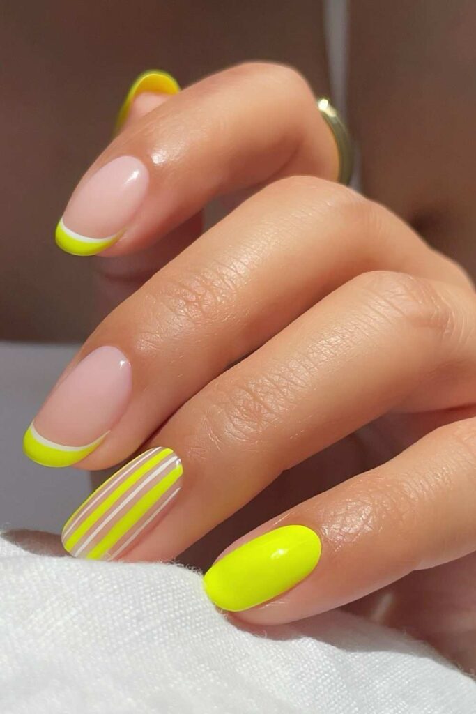 Neon yellow nails with stripes and French tip accent