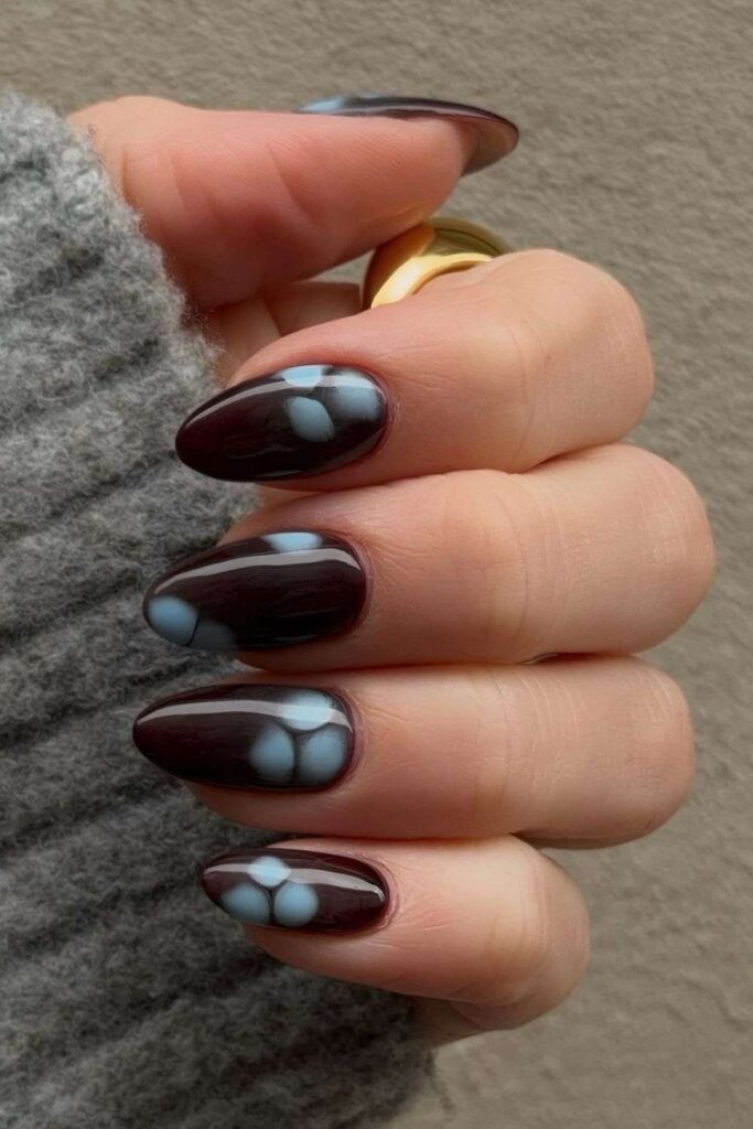 Brown almond nails with blue blooming gel flowers