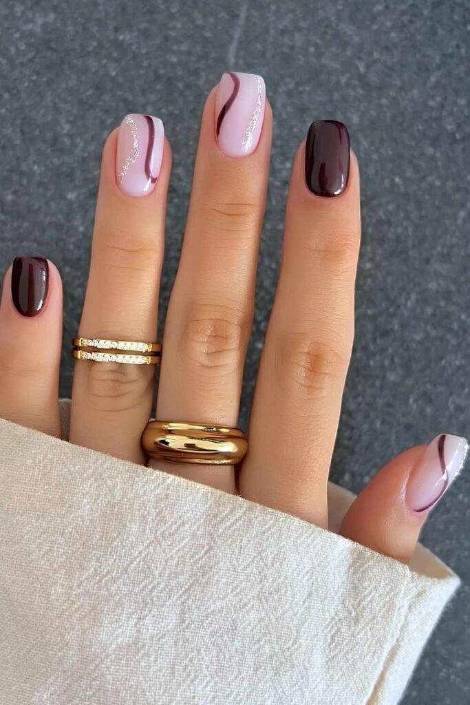 Chocolate brown and blush pink mani with swirls and glitter