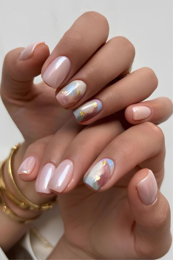 Light pink chrome nails with pastel marbled accent