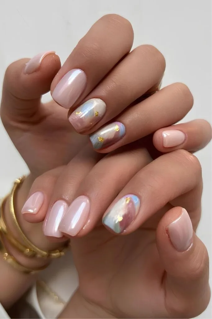 Light pink chrome nails with pastel marbled accent