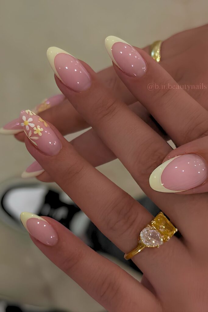 Light yellow French nails with floral accent
