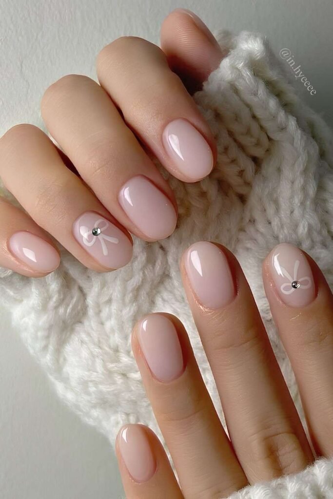 Milky pink nails with bows