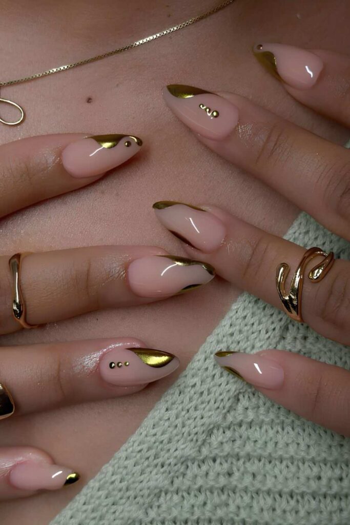 Neutral nails with abstract gold chrome details