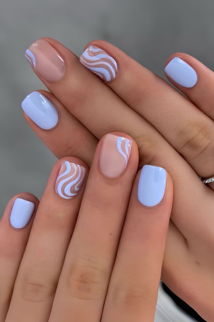 Pastel blue nails with swirls