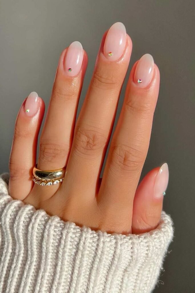 Sheer pink nails with crystals on cuticles