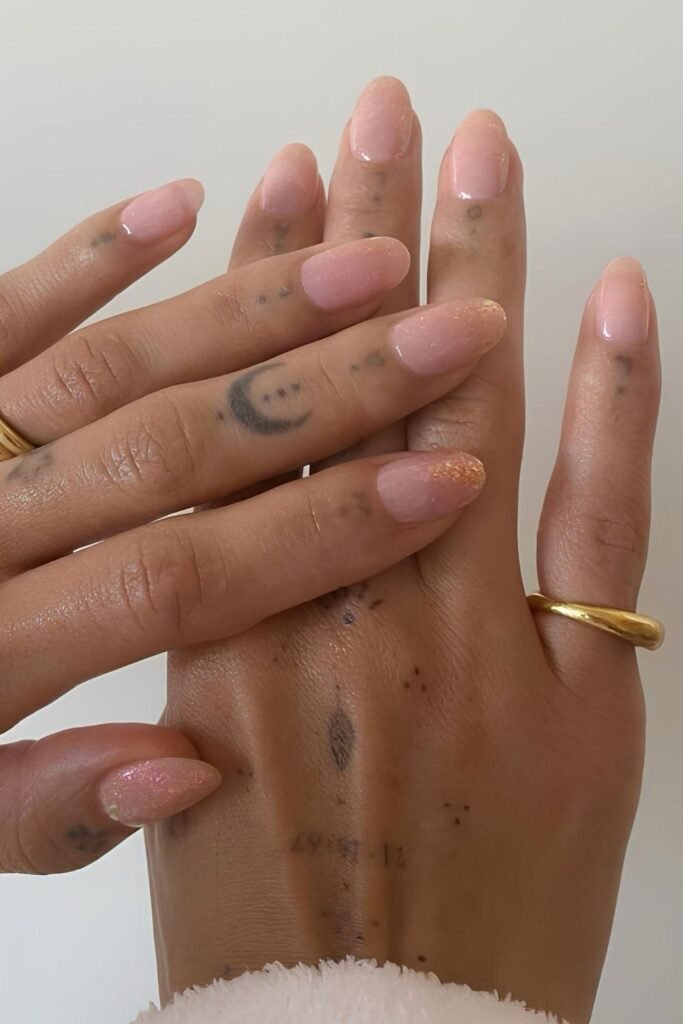 Sheer pink nails with gold shimmer