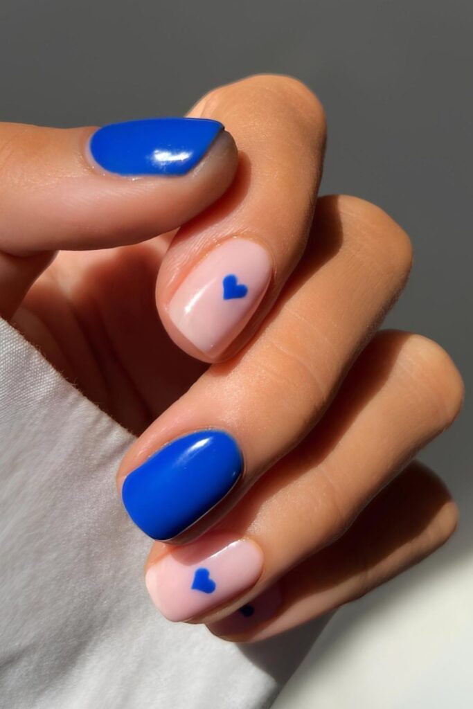 Short royal blue nails with heart accents