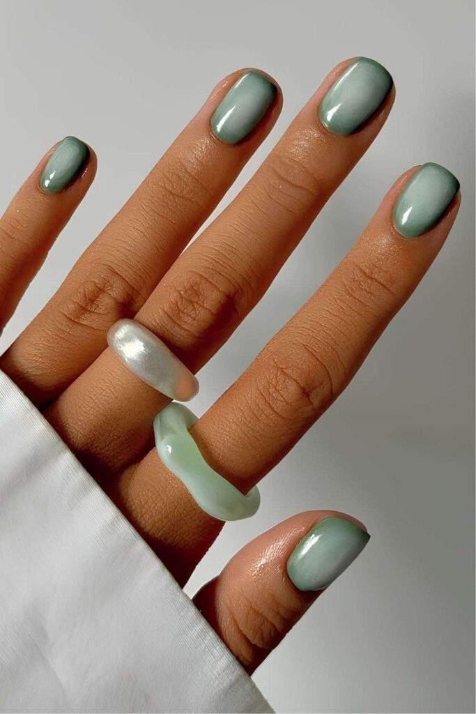 Short sage green mani with aura effect