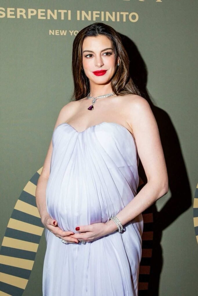 Anne Hathaway with glossy red manicure at Serpenti Infinito event
