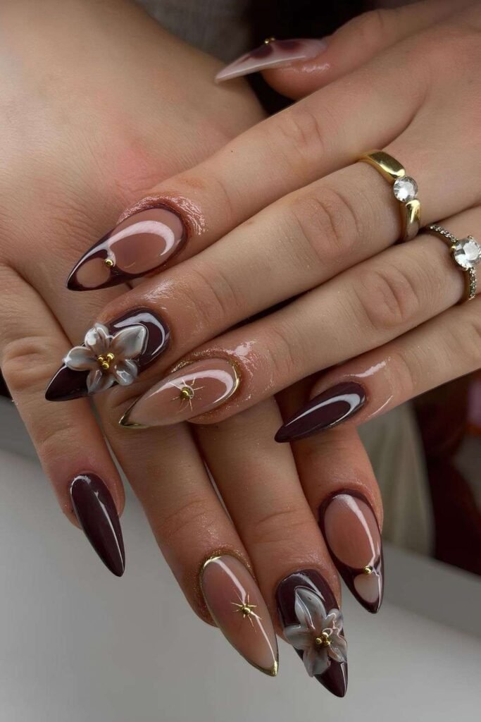 Brown mani with sculpted florals and gold accents