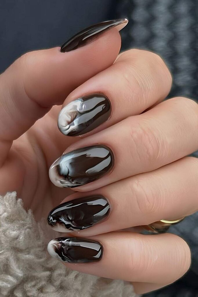 Dark brown mani with creamy white marble swirls