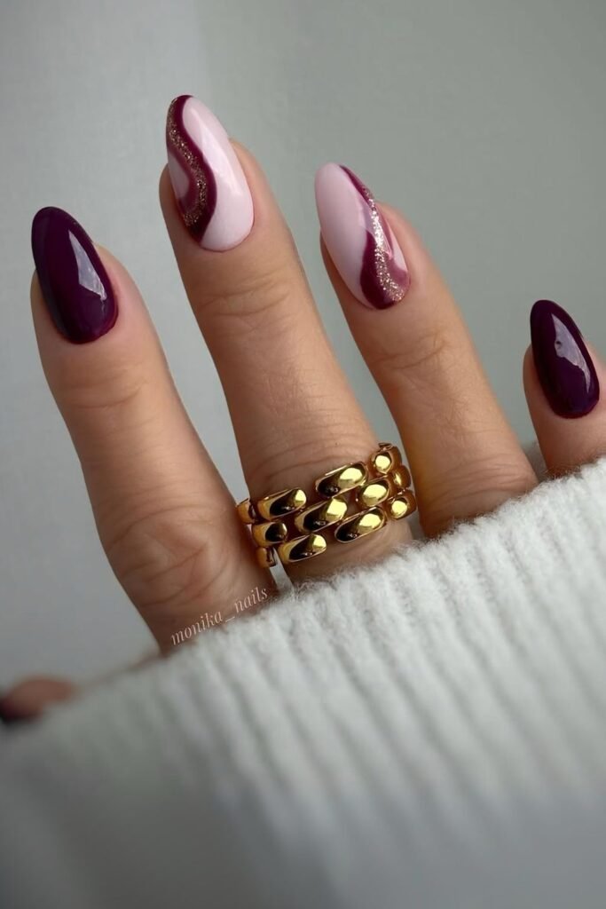 Deep plum and pink nails with swirls