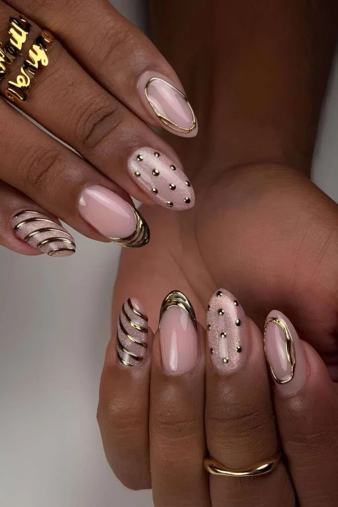 Light pink nails with cat-eye effect and gold chrome details