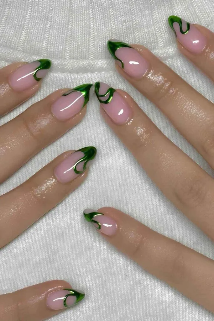 Light pink nails with metallic green swirly tips