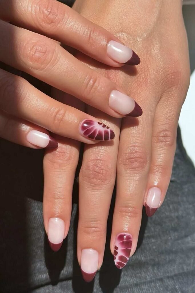 Maroon French nails with blooming gel petal accents