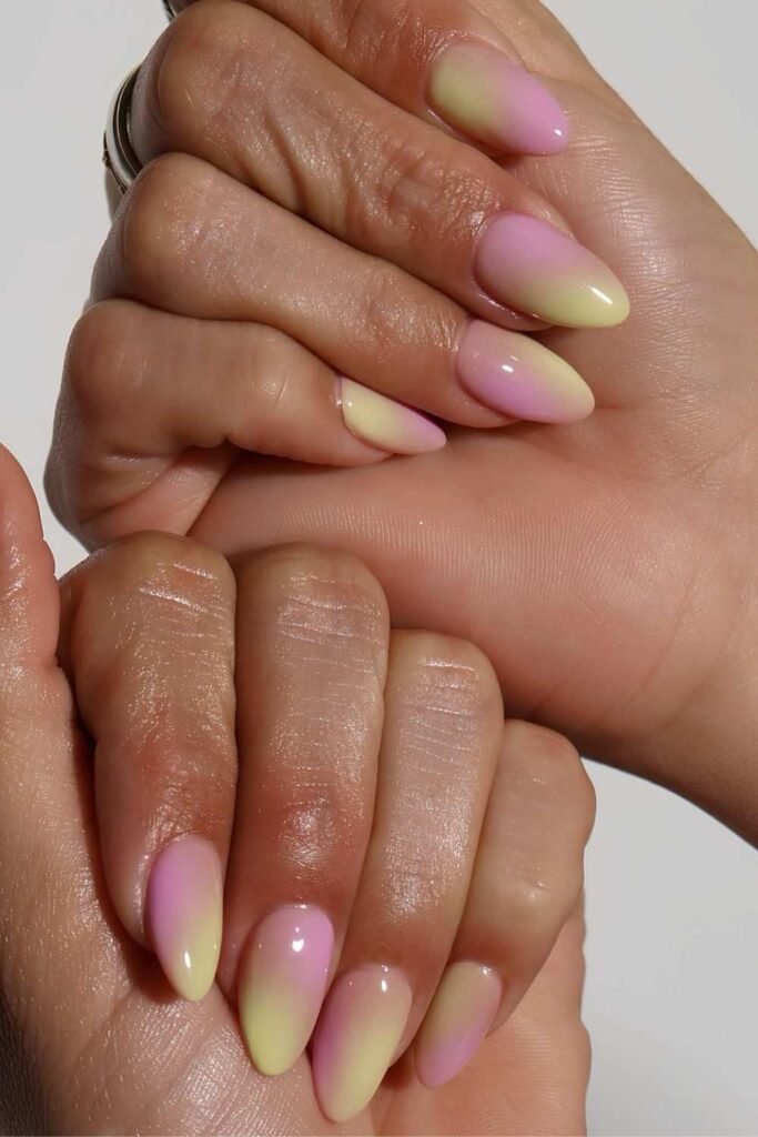 Pink and lemon sorbet ombré nails with a glossy almond finish