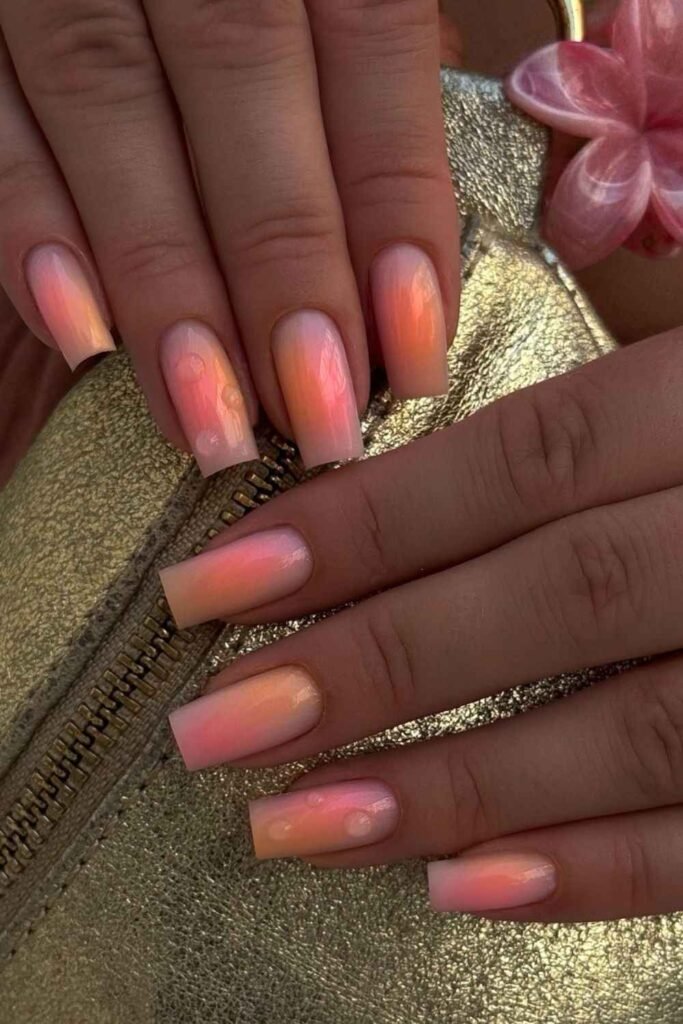 Pink and peach sorbet ombré nails with a soft glowing finish