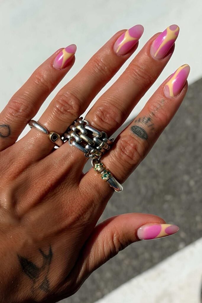 Pink and yellow sorbet nails with glossy abstract swirl designs