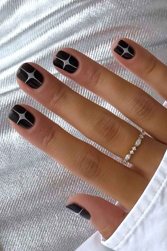Short black mani with metallic silver stars