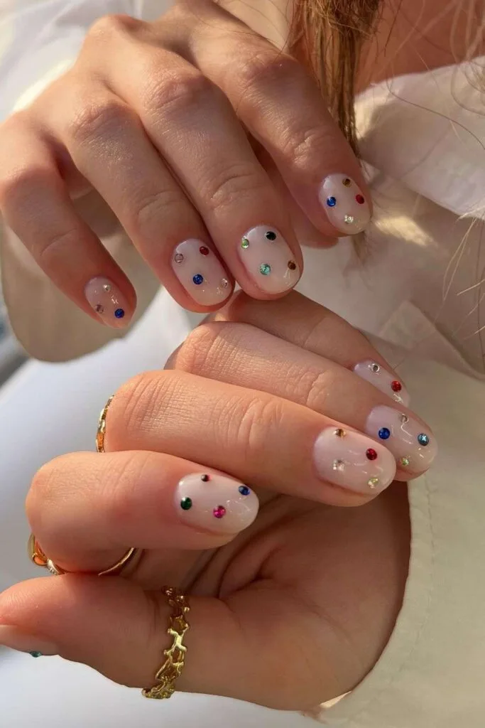 Short milky nails with colorful gems