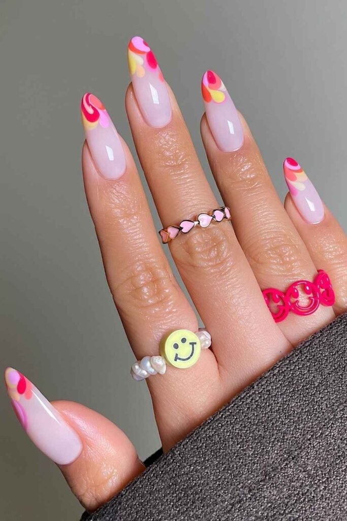 Sorbet French tip nails in pink, coral and yellow shades