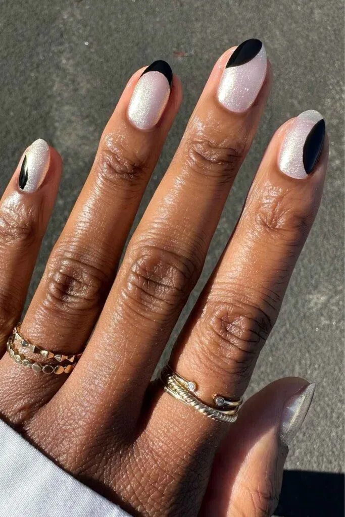 White shimmer and black abstract nails
