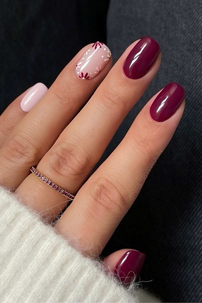 Burgundy nails with floral accent