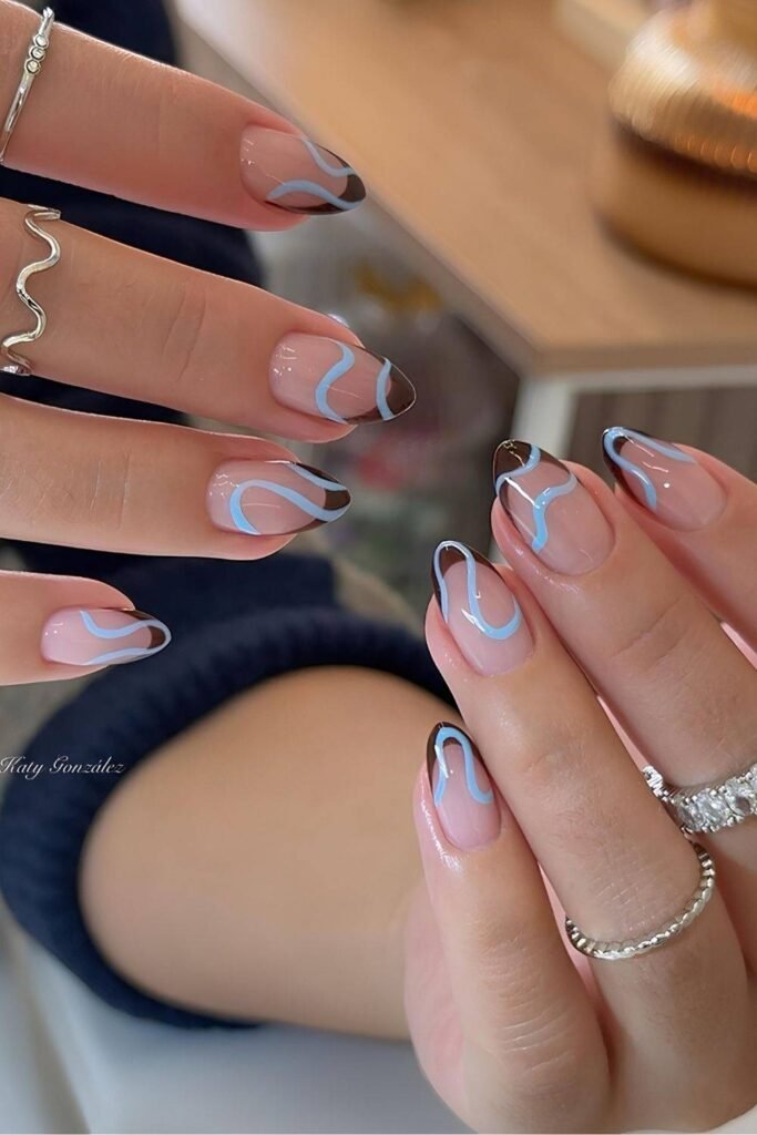 Dark brown French nails with light blue swirls