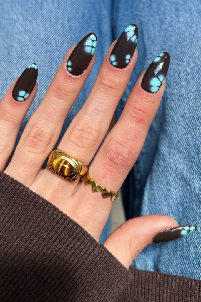 Dark brown almond nails with blue blooming florals